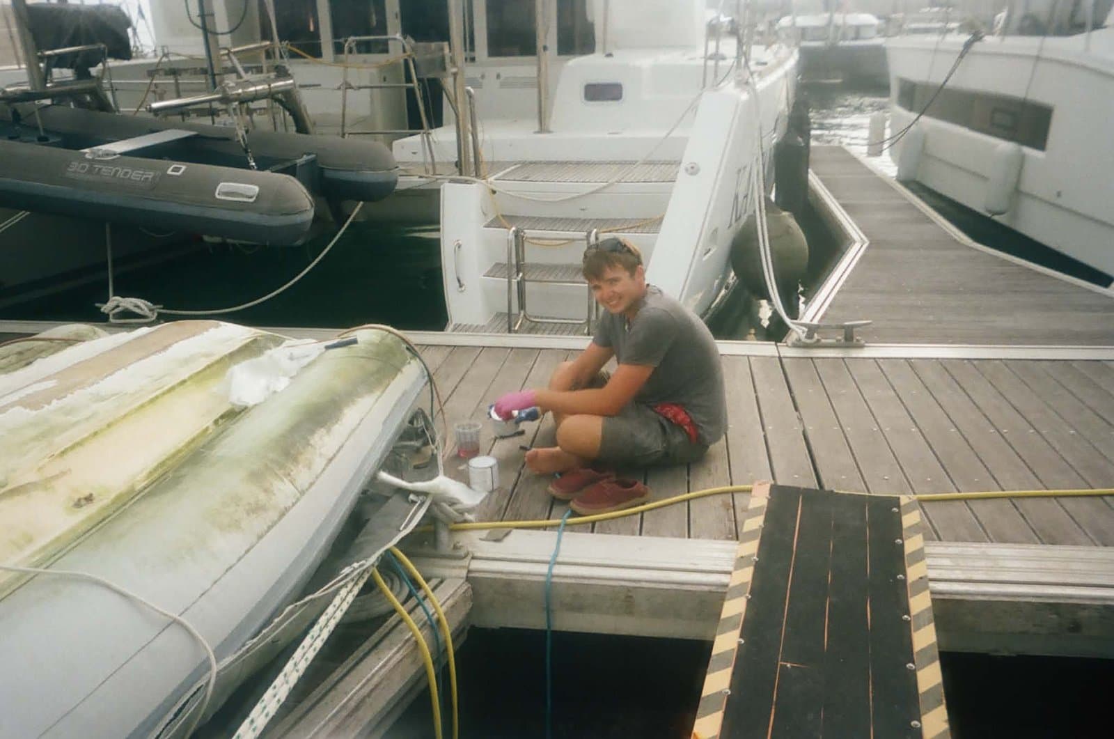 Mateusz Mrosek servicing a tender on a marina pontoon